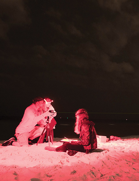 Youth volunteers measure nighttime ambient light conditions at Gulf Islands National Seashore