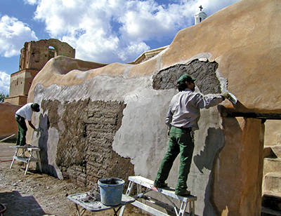 Cultural resource specialists maintain an adobe structure at Tumacacori National Historical Park Cultural resource specialists maintain an adobe structure at Tumacacori National Historical Park