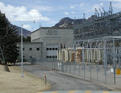 Photo of Estes Powerplant next to a large grid of power-lines 