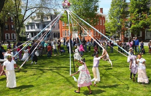 Kids walking around a maypole