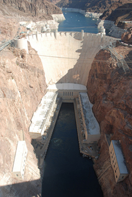 Sky view of the Hoover Dam surrounded by dark water 