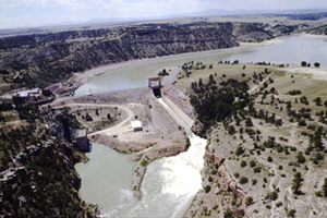 Sky view of Guernsey Dam surrounded by water and trees