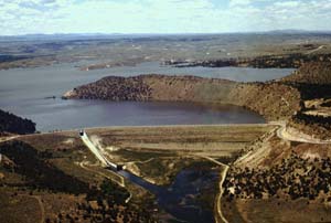 Sky view of Glendo Dam surrounded by large craters and water