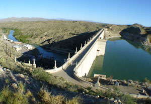 A photo of Elephant Butte Dam with an afternoon sky.