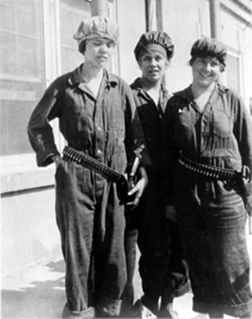 Black and white photo of three women wearing labor suites 