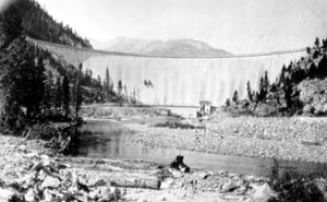 Black and white photo of Gibson Dam surrounded by trees 