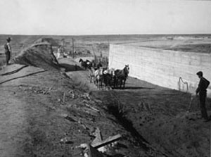 Black and white photo of workers rebuilding Avalon Dam 