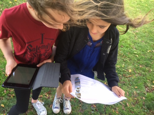 Students holding paper for BioBlitz lesson