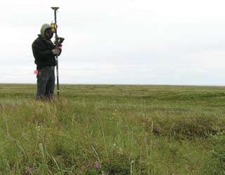 A man mapping previously excavated features. A man mapping previously excavated features.