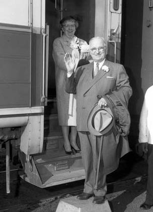 Black and white photo of a man and a woman both wearing glasses 