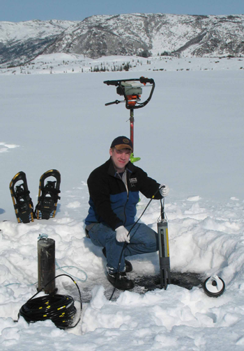 Researcher installing a temperature sensor in Wonder Lake Researcher installing a temperature sensor in Wonder Lake