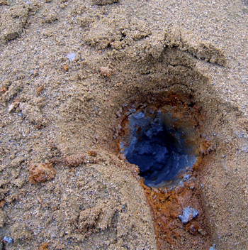 A hole in the tailings pile showing antimony A hole in the tailings pile showing antimony