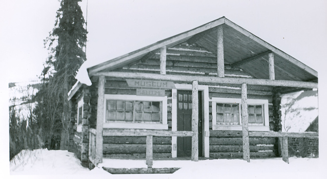 black and white photo of a log cabin museum in 1943