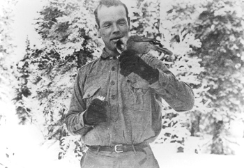 photo of a man holding a bird