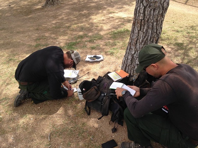 Crew members review the 9-Line Medical Incident Report format in the Incident Response Pocket Guide