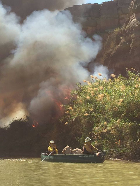 Firefighters reach river cane by boat for ignition during a prescribed burn along the Rio Grande Firefighters reach river cane by boat for ignition during a prescribed burn along the Rio Grande