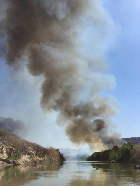 Firefighters canoeing on the Rio Grande during a prescribed burn along the Rio Grande Firefighters canoeing on the Rio Grande during a prescribed burn along the Rio Grande
