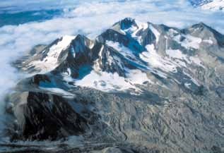 Aerial view of four mountain peaks in the clouds