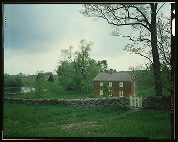 Shakertown village in Mercer County, Kentucky. A House with sky and grass in background Shakertown village in Mercer County, Kentucky. A House with sky and grass in background