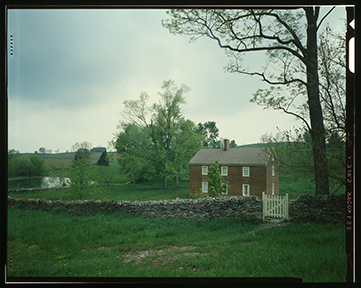 Shakertown village in Mercer County, Kentucky. A House with sky and grass in background