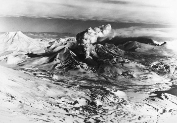 aerial view of a volcano erupting smoke