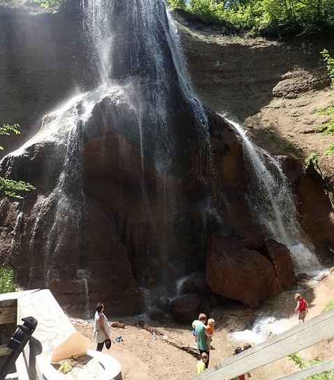 People standing below Smith Falls