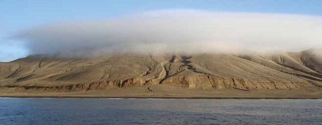 a rocky island covered by a cloud a rocky island covered by a cloud