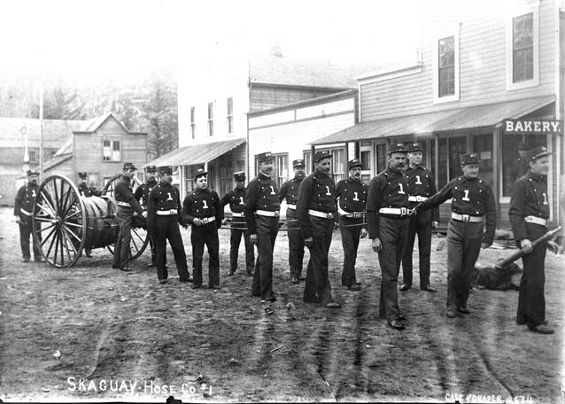 Men pulling hose cart. 