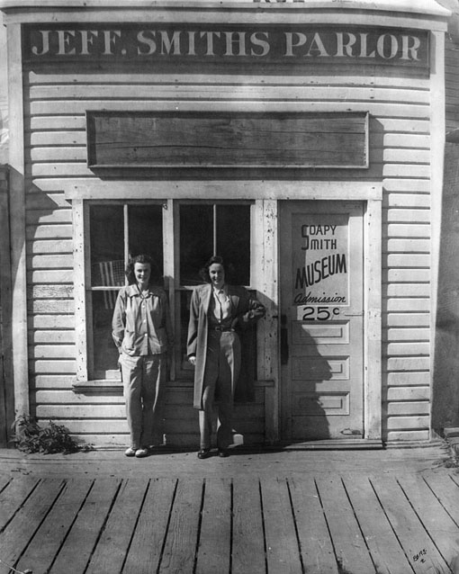 Two young women in front of Jeff. Smiths Parlor. Two young women in front of Jeff. Smiths Parlor.