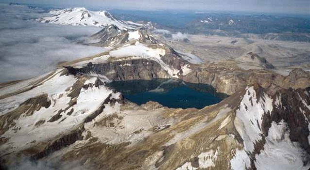 aerial view of snow-capped mountains and cone