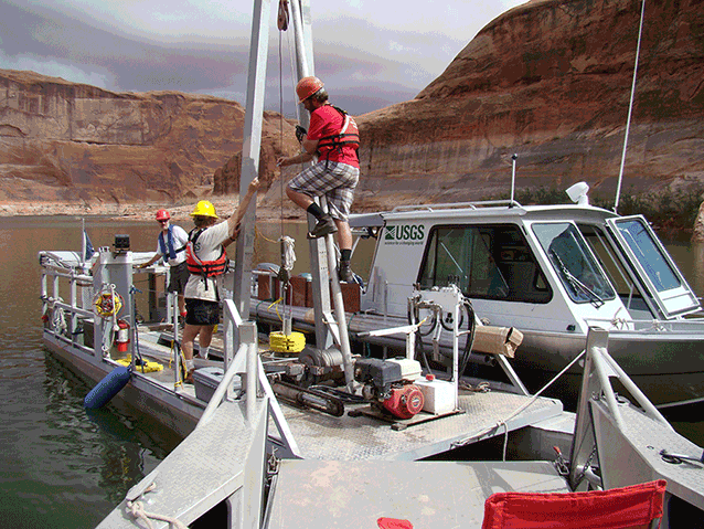 Boat with scientific equipment. people with lifejackets operate equipment.