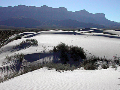 White dunes against a mountainous backdrop