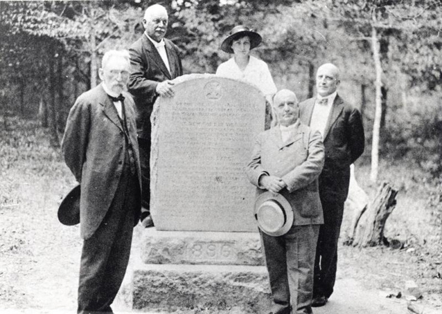 Virginia Dare marker in 1896 with five men and one woman standing around it