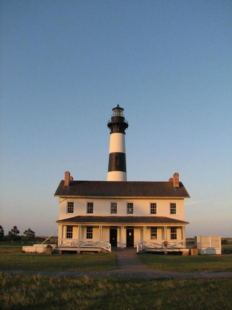 Present-day image of Bodie Island Light Station at sunset, showing tower and quarters Present-day image of Bodie Island Light Station at sunset, showing tower and quarters