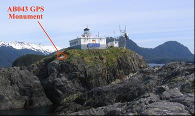 lighthouse atop a cliff, GPS unit labeled on side of hill