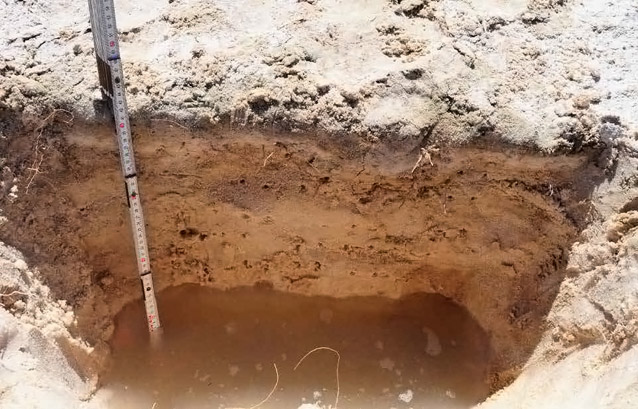 Water filling the bottom of a shallow hole Water filling the bottom of a shallow hole