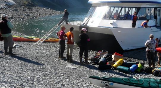 boat off-loads campers on a beach