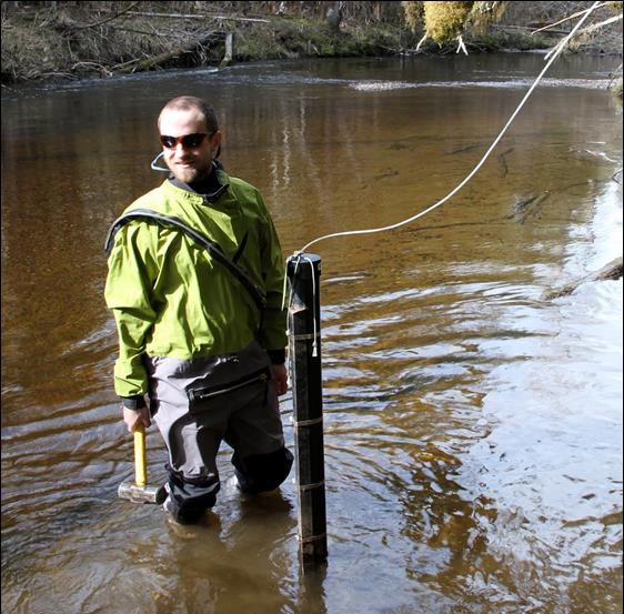 man stands in a river man stands in a river