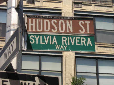 A street sign that says "Hudson St." and "Sylvia Rivera Way" A street sign that says "Hudson St." and "Sylvia Rivera Way"