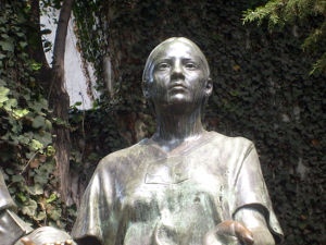 A statue of a woman surrounded by ivy