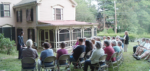 group of people gathering in the lawn of an historic house to learn about fire prevention group of people gathering in the lawn of an historic house to learn about fire prevention