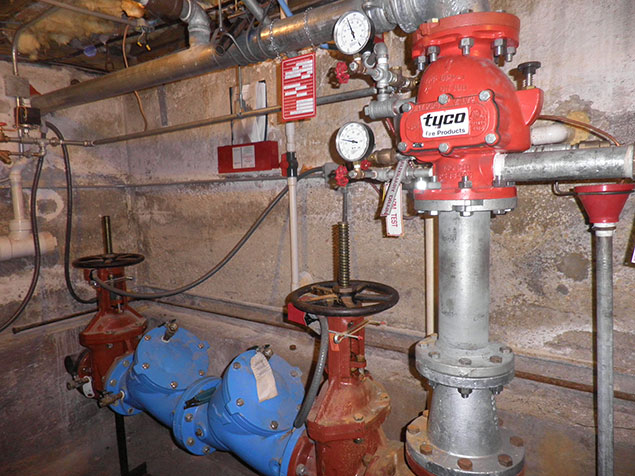 View of pipes, and fire suppression equipment View of pipes, and fire suppression equipment