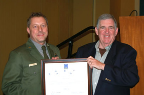 Park employee receiving an award and smiling. 