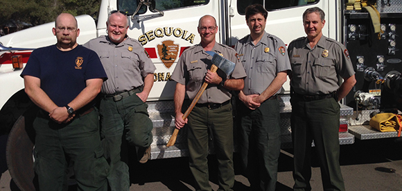 Sequoia and Kings Canyon fire staff pose for a photo with fire fighting tools.