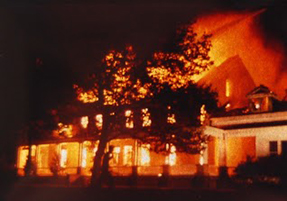 Exterior building completely in flames at night Exterior building completely in flames at night