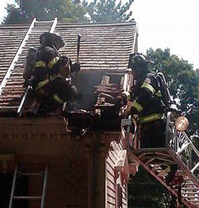 Firefighters working on the exterior roof.