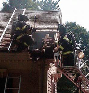 Firefighters working on the exterior roof. Firefighters working on the exterior roof.