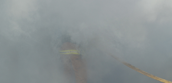 Smoke with a small view of a firefighter