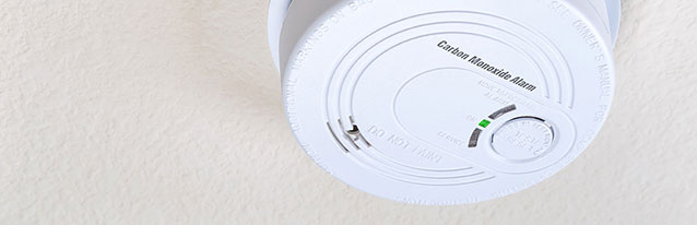 white carbon monoxide alarm on the ceiling