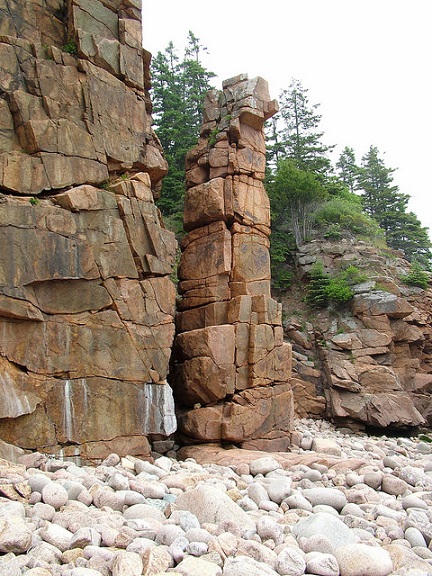 Granite outcrops contrast to boulder and cobble beach (Acadia National Park)